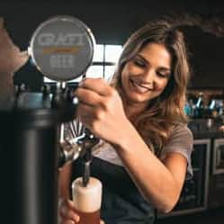 Bartender holding glass smiling