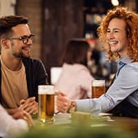 Bartender serving beer smiling